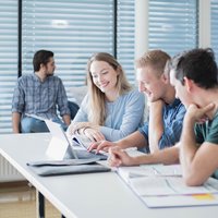 Melde dich gleich online für dein Studium an. Foto: © MUL Studierende vor einem Laptop.